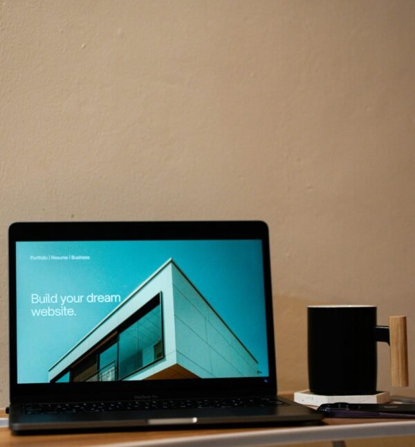 a laptop computer sitting on top of a wooden desk