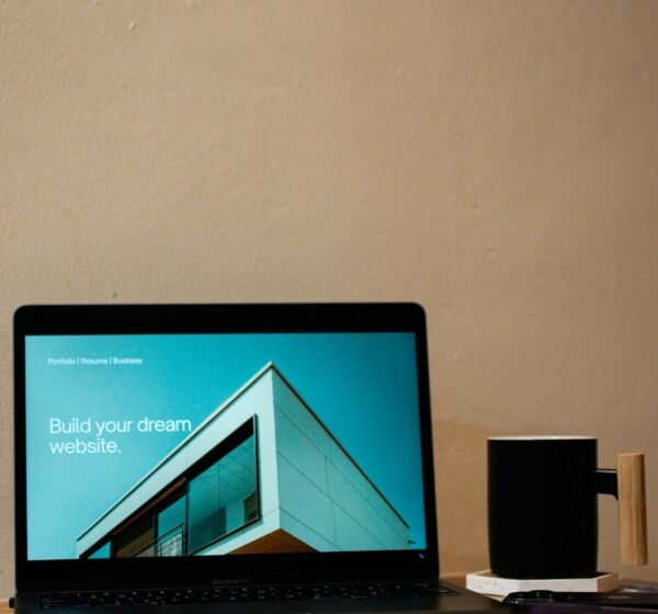 a laptop computer sitting on top of a wooden desk