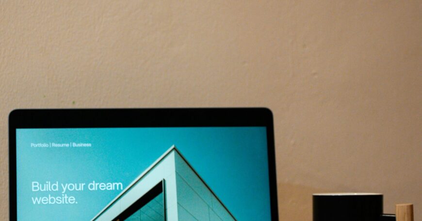a laptop computer sitting on top of a wooden desk